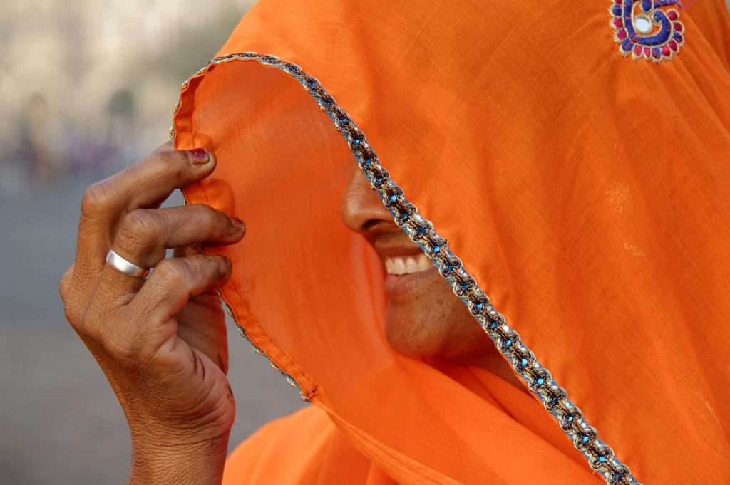 A lady wears an orange sari in Rajasthan, India